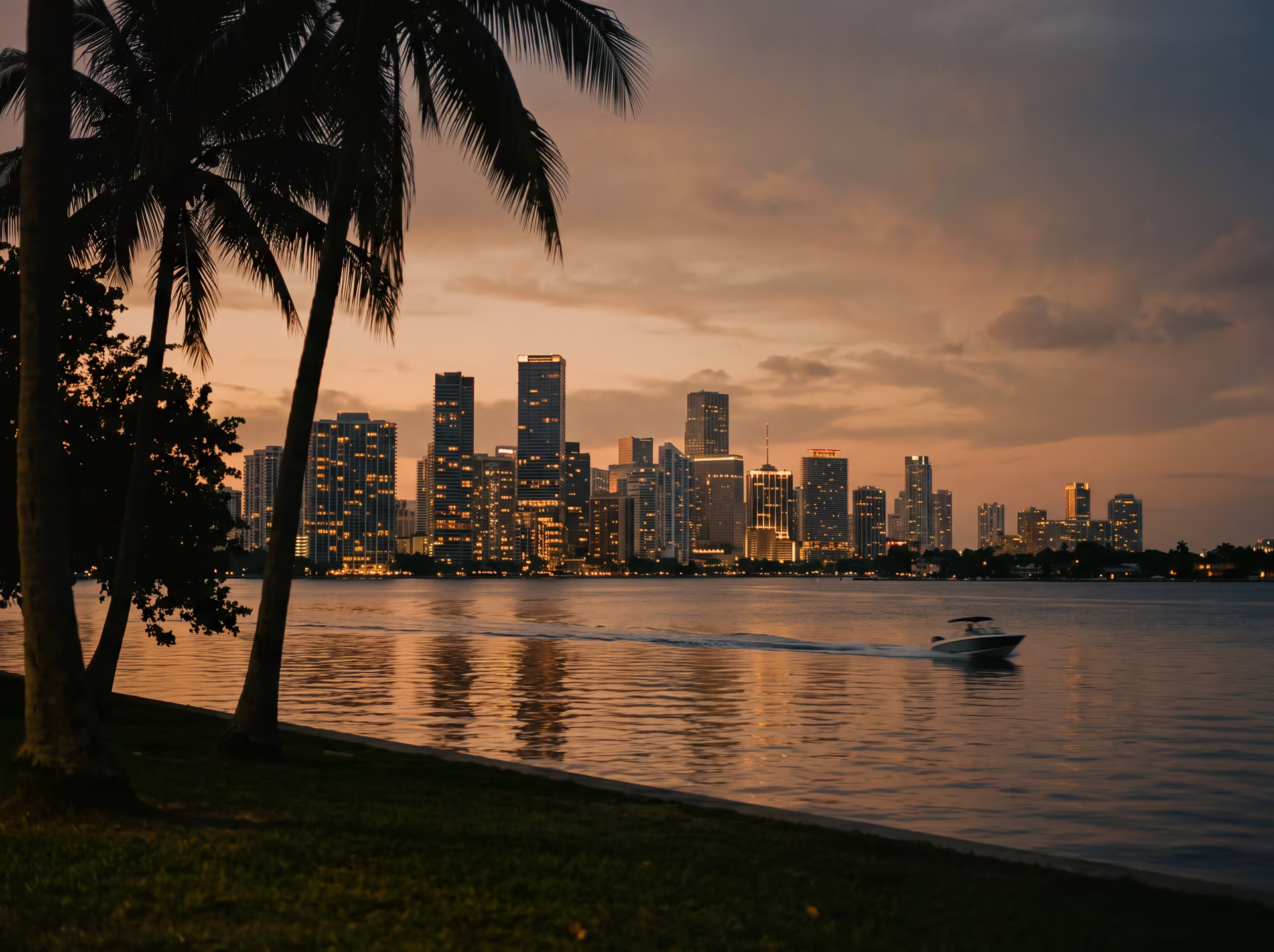 Miami skyline silhouetted above Biscayne Bay at dusk